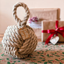 Load image into Gallery viewer, Country cottage inspired natural rope door stop, hand laid natural fibre flax hemp rope made in the UK crafted into a monkey fist knot doorstop with a personalised tag, inspired by coastal, nautical and country cottage interiors
