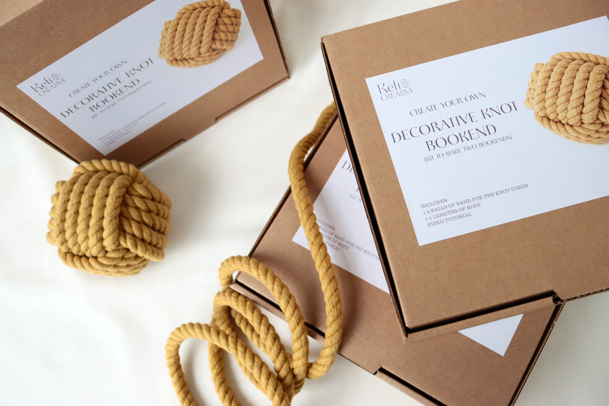 Decorative knot bookends with packaging on a white background