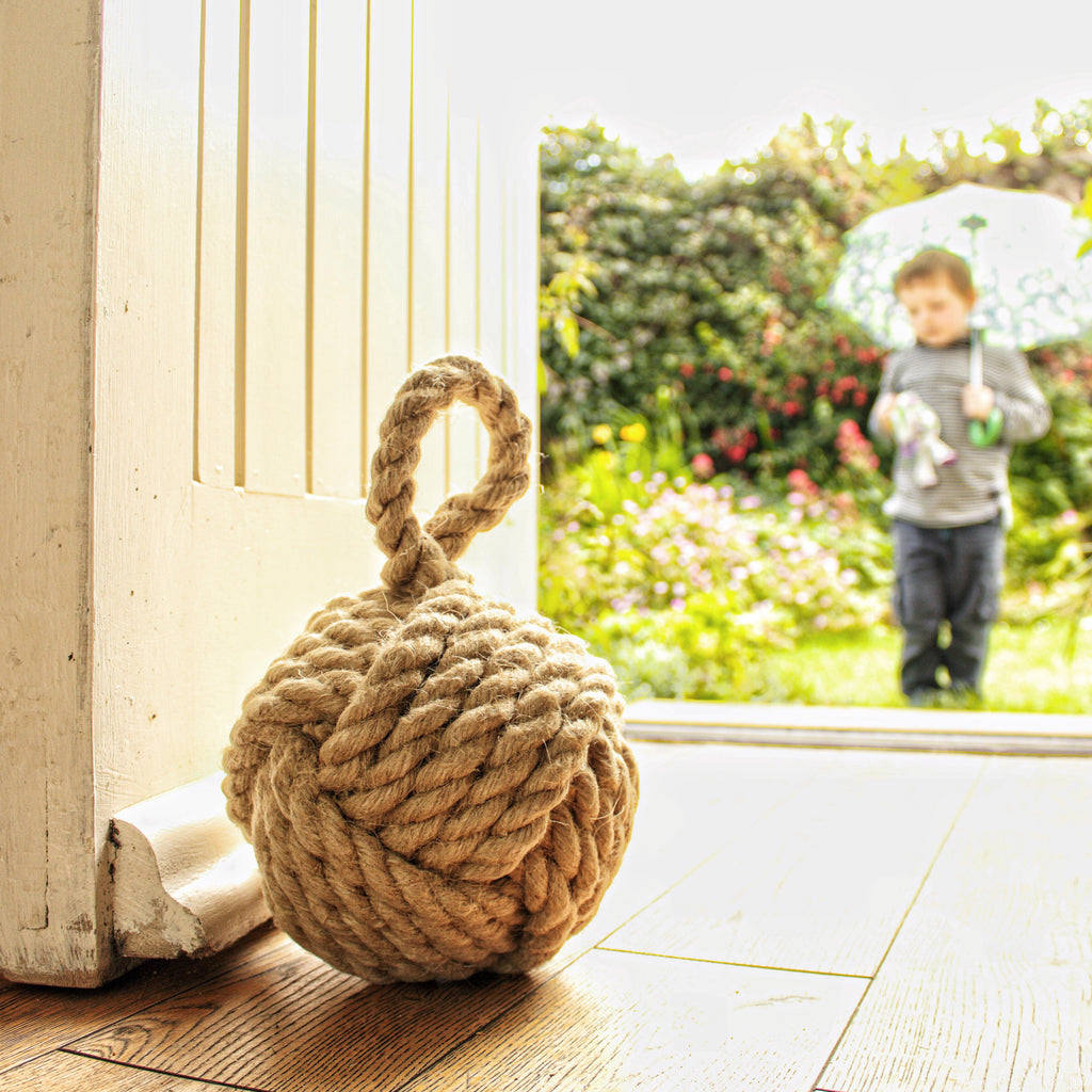 Country cottage inspired natural rope door stop, hand laid natural fibre flax hemp rope made in the UK crafted into a monkey fist knot doorstop