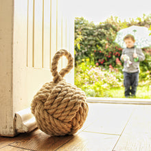 Load image into Gallery viewer, Country cottage inspired natural rope door stop, hand laid natural fibre flax hemp rope made in the UK crafted into a monkey fist knot doorstop
