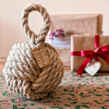 Load image into Gallery viewer, Country cottage inspired natural rope door stop, hand laid natural fibre flax hemp rope made in the UK crafted into a monkey fist knot doorstop with a personalised tag, inspired by coastal, nautical and country cottage interiors
