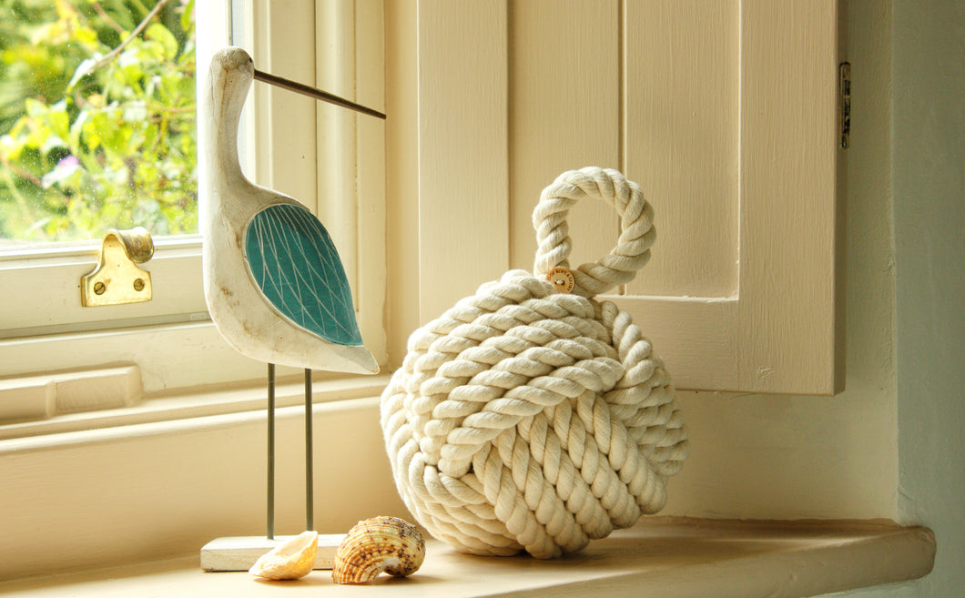 Country cottage inspired natural rope door stop, hand laid natural fibre cotton rope made in the UK crafted into a monkey fist knot doorstop